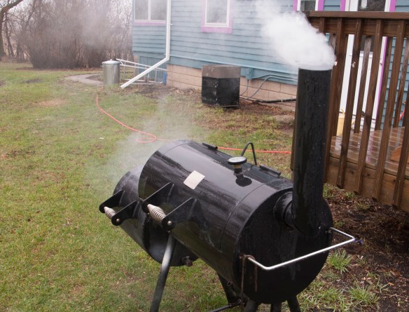 Smoke from the pecan shells escapes through the chimney of our new, secondhand offset smoker. 